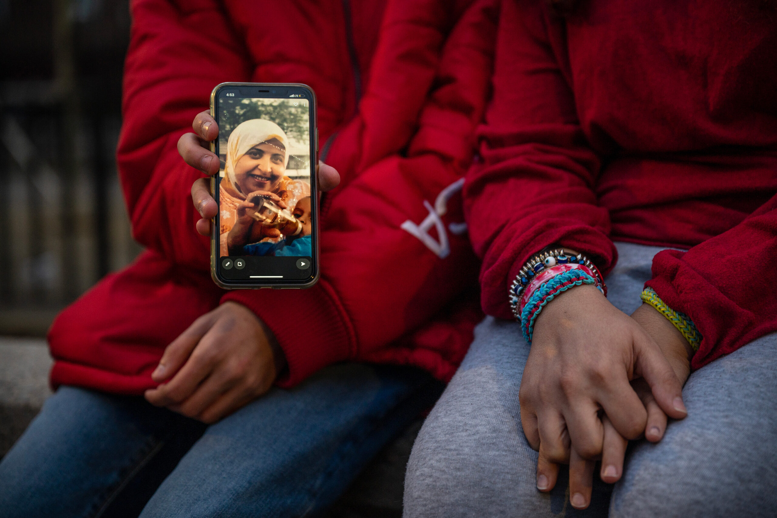 Rana and Ibrahim Ibrahim hold a photo of their mother, Fatma Atia.